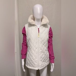 White puffer vest. Gold zipper.